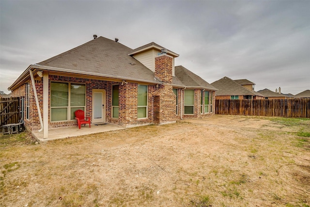 back of property featuring a lawn and a patio area