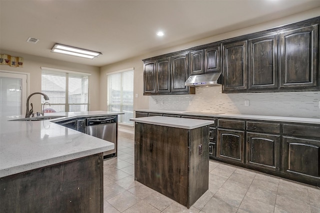 kitchen featuring sink, light tile patterned floors, dishwasher, dark brown cabinets, and a center island