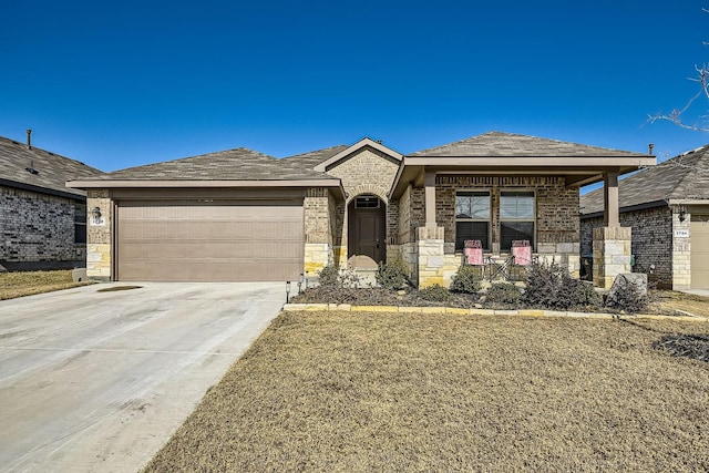 prairie-style home featuring a garage and a front yard