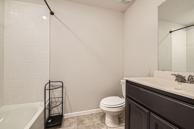 full bathroom with tile patterned flooring, vanity, tiled shower / bath, and toilet