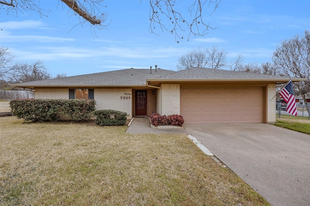 single story home featuring a garage and a front lawn