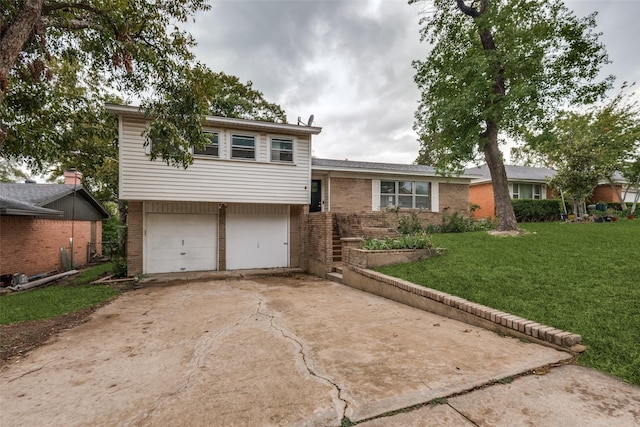 tri-level home featuring a garage and a front yard