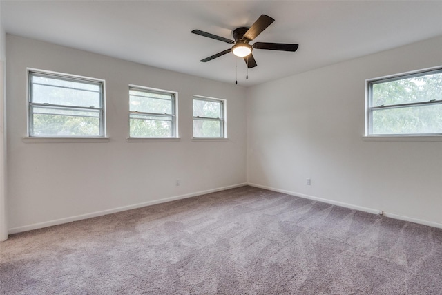 unfurnished room featuring carpet, plenty of natural light, and ceiling fan