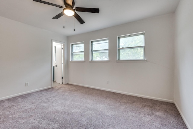 spare room featuring ceiling fan and light colored carpet