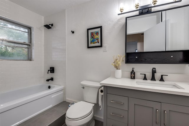 full bathroom with tile patterned flooring, vanity, toilet, and tiled shower / bath