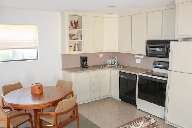 kitchen featuring sink, black appliances, and light tile patterned flooring