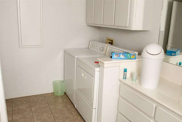 laundry room with light tile patterned flooring and washing machine and clothes dryer