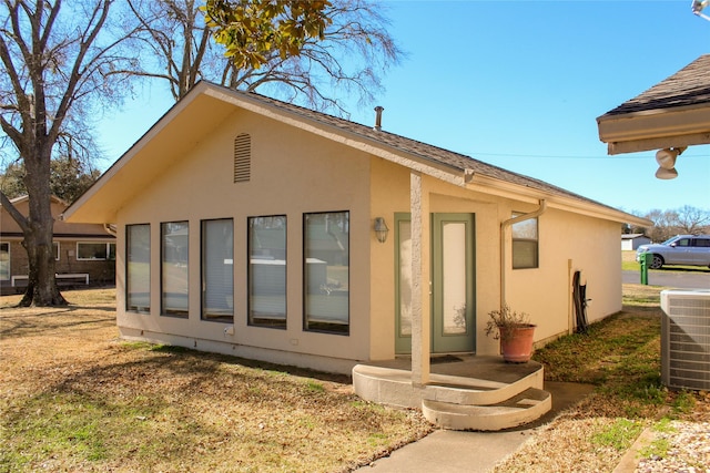 rear view of house featuring central air condition unit