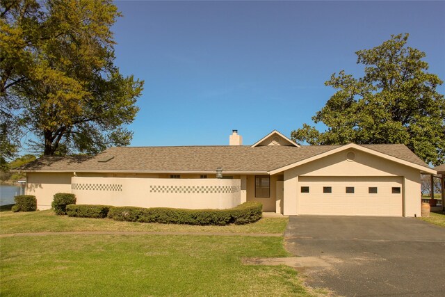 single story home featuring a garage, a water view, and cooling unit