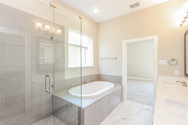 bathroom with vanity and shower with separate bathtub