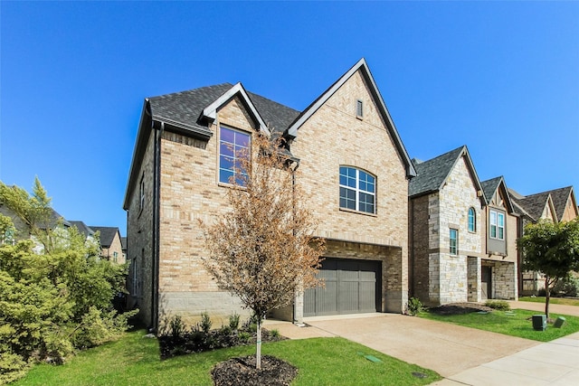 view of front of property featuring a garage and a front yard