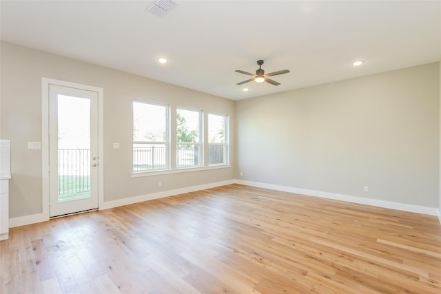 unfurnished room with ceiling fan and light wood-type flooring