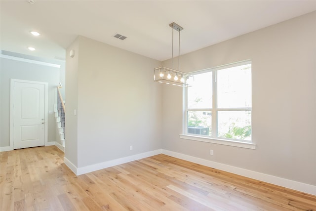 empty room with light hardwood / wood-style flooring