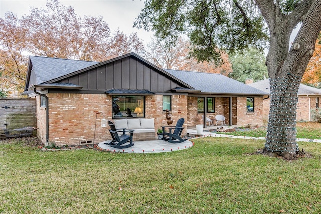 back of house with a patio and a lawn