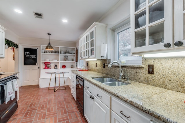 kitchen with sink, decorative light fixtures, and white cabinets