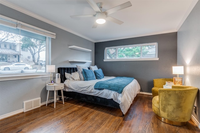 bedroom featuring dark hardwood / wood-style flooring, multiple windows, ornamental molding, and ceiling fan