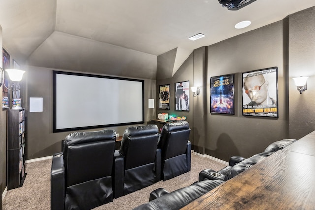 carpeted home theater featuring lofted ceiling