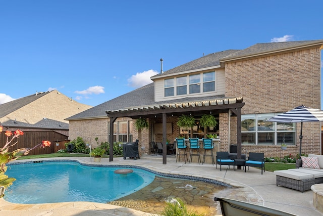 view of swimming pool featuring a bar, a grill, a pergola, and a patio