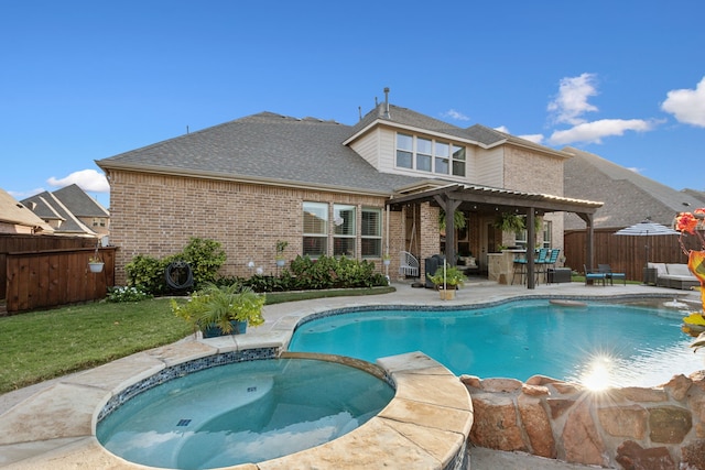 view of pool with a yard, a pergola, a patio, and an in ground hot tub