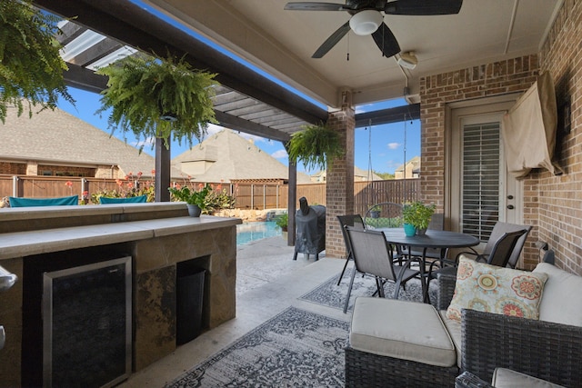 view of patio with an outdoor bar and ceiling fan