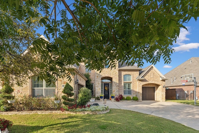 view of front of home featuring a garage and a front yard