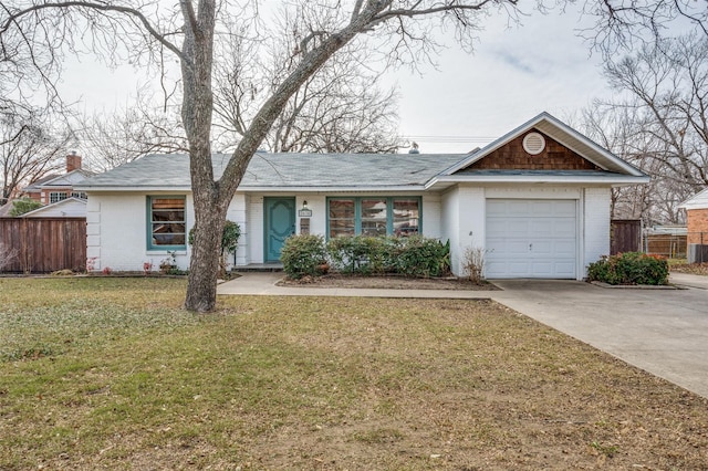 ranch-style home featuring a garage and a front lawn