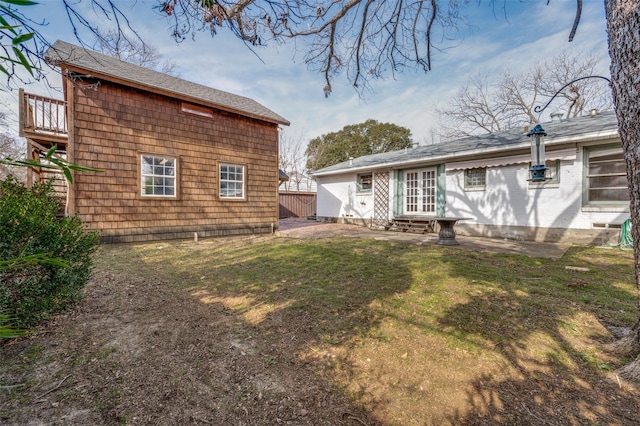 rear view of property featuring a yard