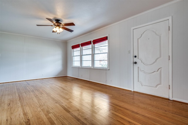 entryway featuring ornamental molding, ceiling fan, and light hardwood / wood-style flooring