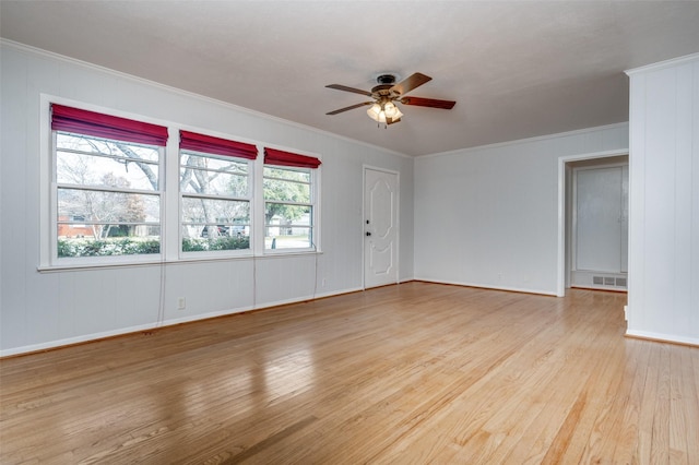 empty room featuring crown molding, ceiling fan, and light wood-type flooring