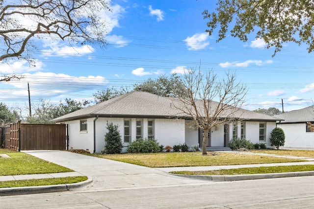 ranch-style house with a front lawn