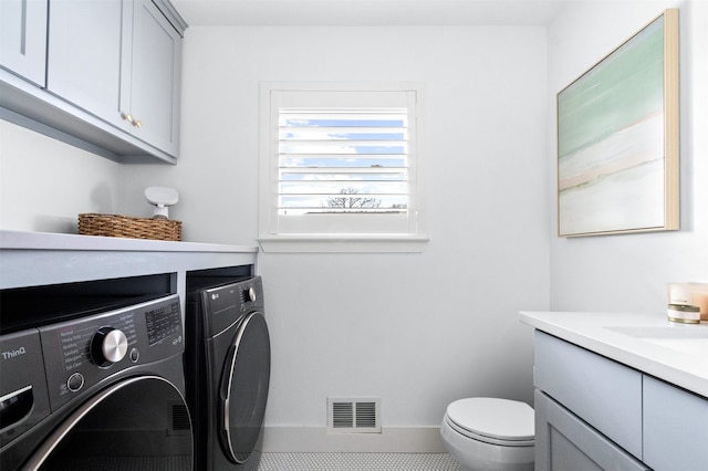 washroom featuring tile patterned flooring, sink, and independent washer and dryer