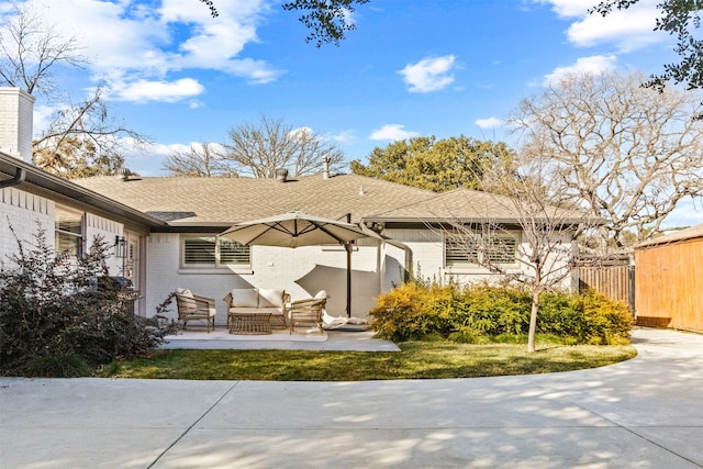 back of property featuring a yard, an outdoor hangout area, and a patio