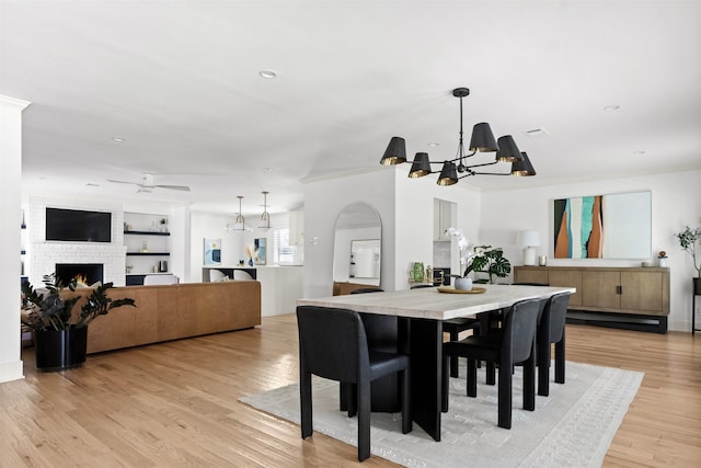 dining area with crown molding, plenty of natural light, light hardwood / wood-style floors, and a notable chandelier