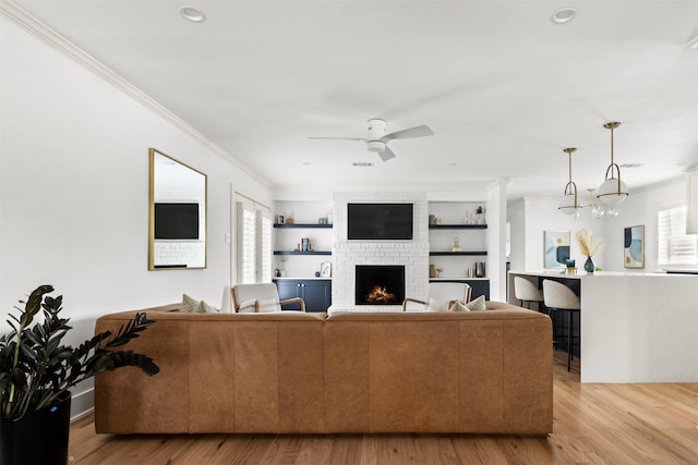 kitchen featuring blue cabinetry, sink, decorative light fixtures, a center island, and white cabinets