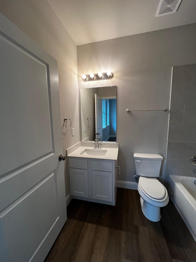 bathroom with wood-type flooring, toilet, and vanity