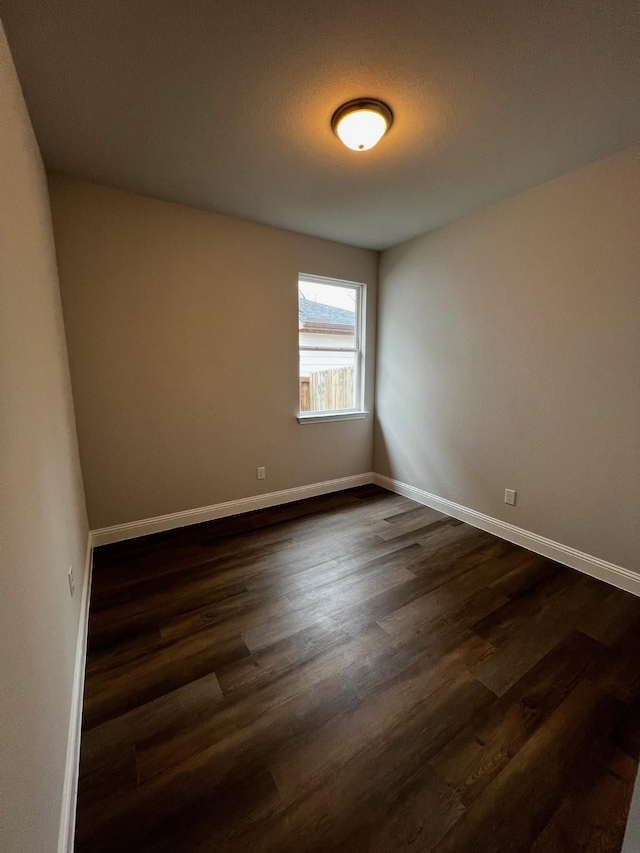 unfurnished room featuring dark hardwood / wood-style flooring