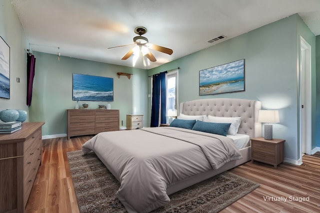 bedroom with wood-type flooring and ceiling fan