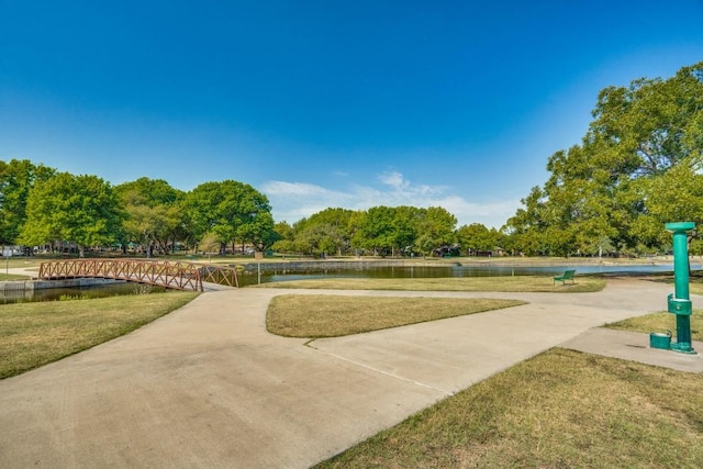 view of property's community featuring a water view and a lawn