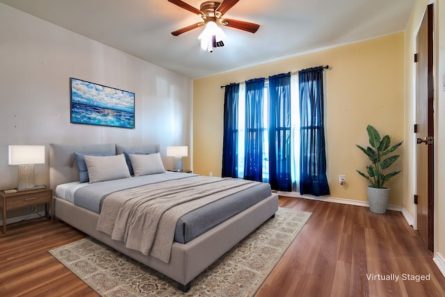 bedroom with hardwood / wood-style floors and ceiling fan