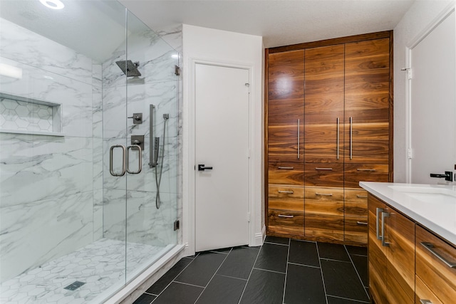 bathroom featuring vanity, tile patterned floors, and walk in shower