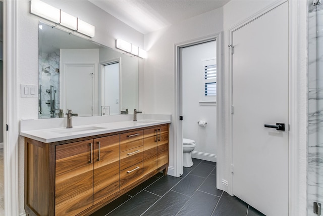 bathroom with tile patterned floors, vanity, toilet, and a shower with door