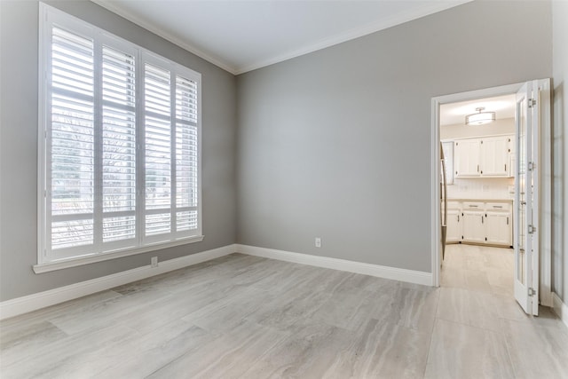 spare room with crown molding and a healthy amount of sunlight