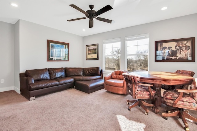 living room featuring light carpet and ceiling fan