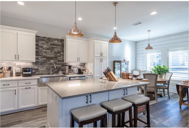 kitchen featuring pendant lighting, white cabinets, and a kitchen island