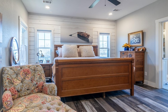 bedroom featuring dark wood-style floors, visible vents, and multiple windows