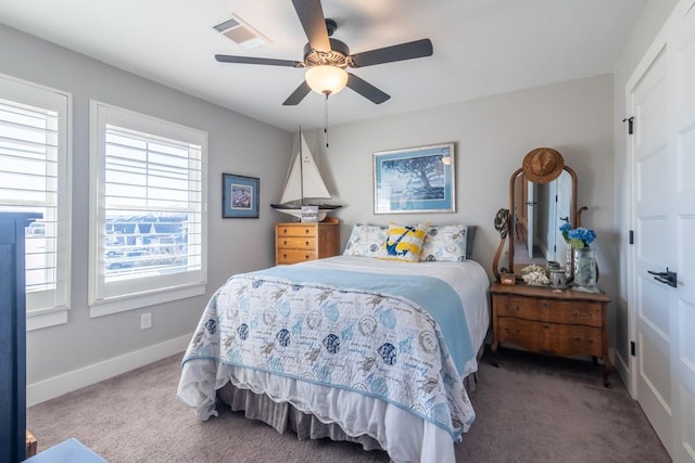 carpeted bedroom with a ceiling fan, baseboards, and visible vents