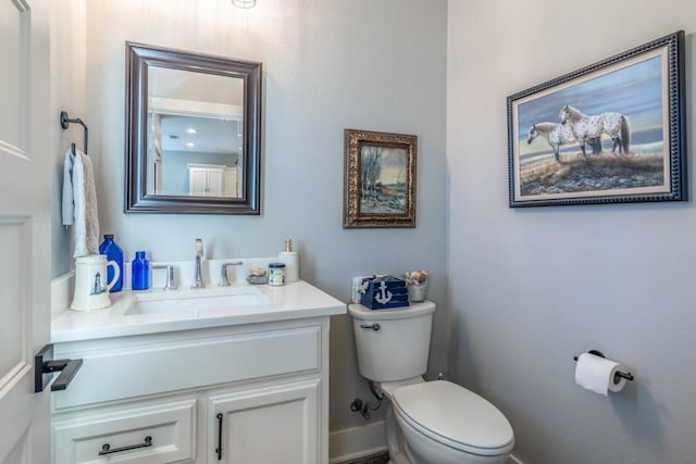 bathroom with toilet and vanity