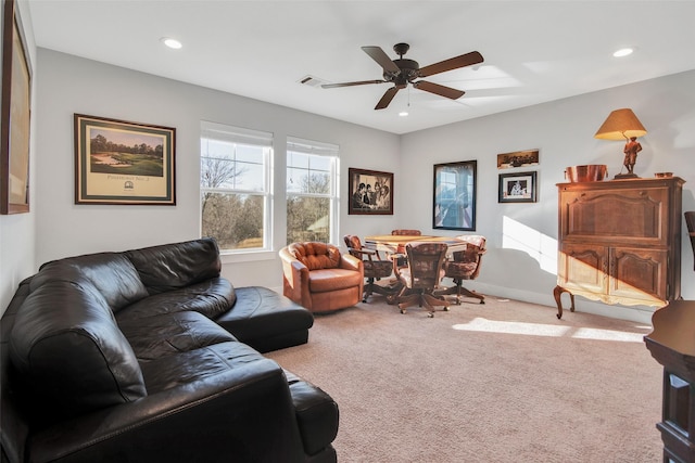 carpeted living room featuring ceiling fan