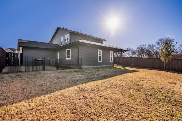 back of house with a fenced backyard