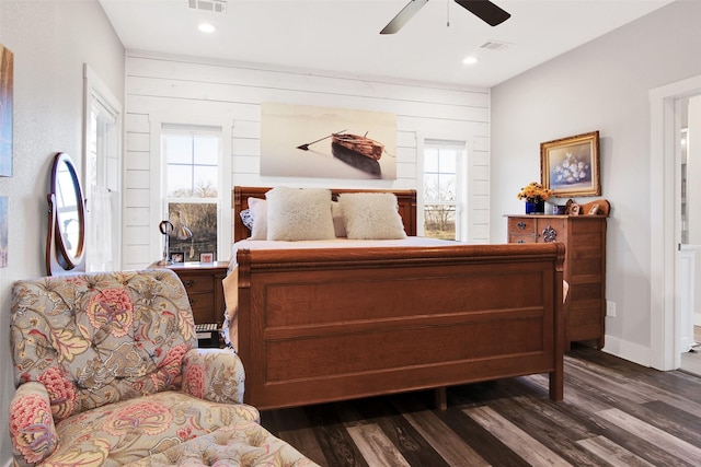 bedroom with dark hardwood / wood-style flooring and ceiling fan